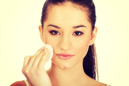 Beautiful woman cleaning make up with cotton pad.の写真素材