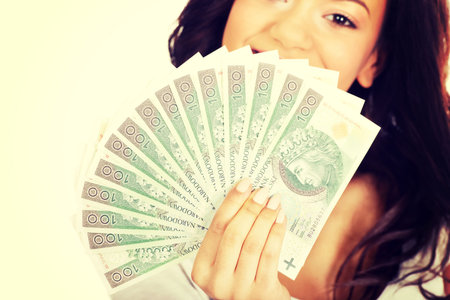 Happy african woman holding polish money.
