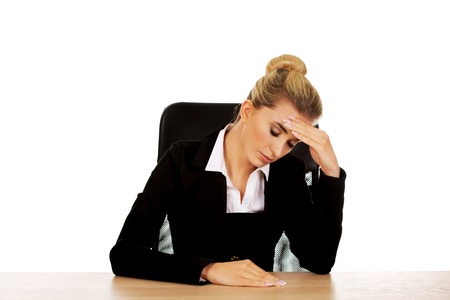 Beautiful worried businesswoman behind the desk.の写真素材