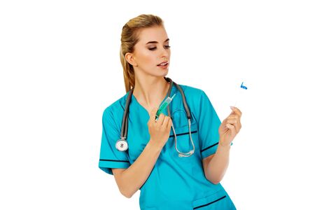Female nurse with two syringes in the hands.の写真素材
