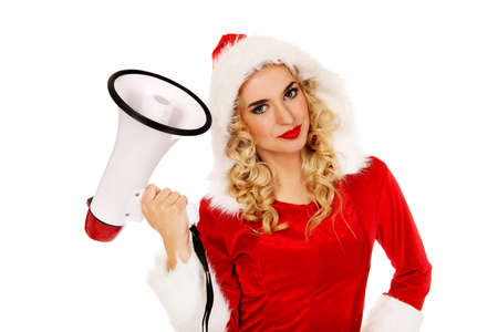 Young beautiful santa woman holding megaphone.の写真素材