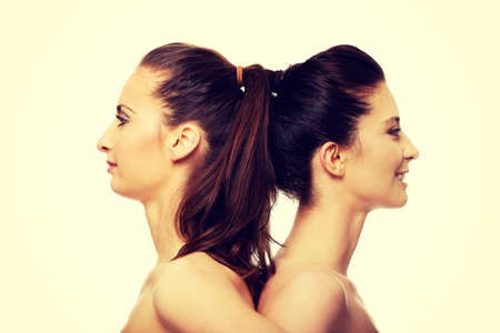 Two attractive topless sisters with make up.の写真素材