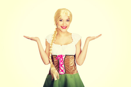 Woman wearing traditional Bavarian dress with open hands.の写真素材