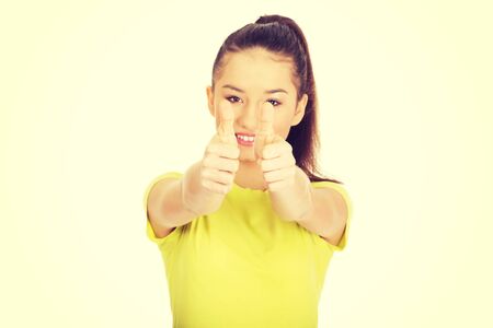Young happy student woman showing thumbs up.の写真素材