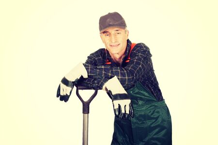 Smiling experienced gardener with a spadeの写真素材