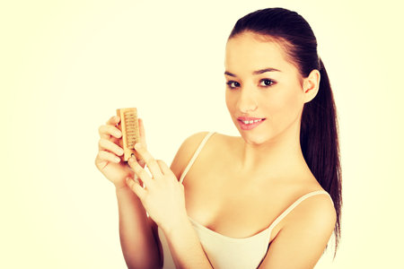 Young woman cleaning her nails with brush.の写真素材