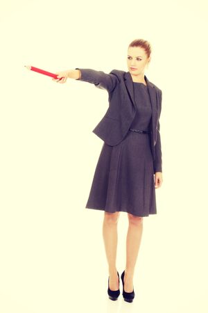 Attractive modern business woman pointing with pencil.の写真素材