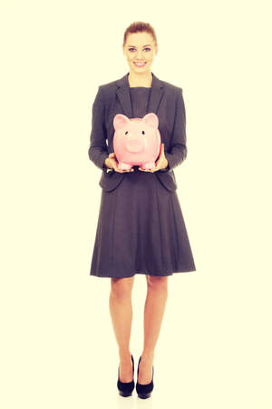 Business woman saving money in piggybank.の写真素材