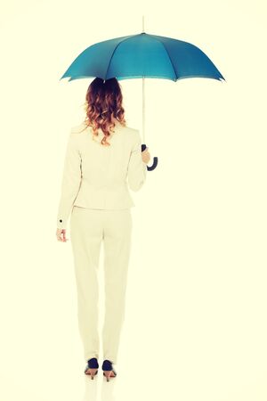 Attractive businesswoman holding an umbrella.の写真素材