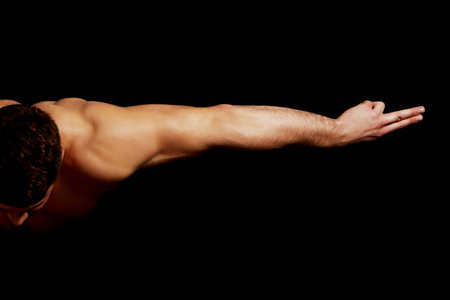 Artistic muscular man bending down and stretching arms.の写真素材