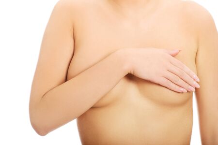 Beautiful slim woman covering her breast.の写真素材