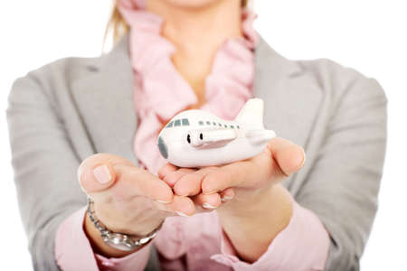 Beautiful business woman holding an airplane model.の写真素材