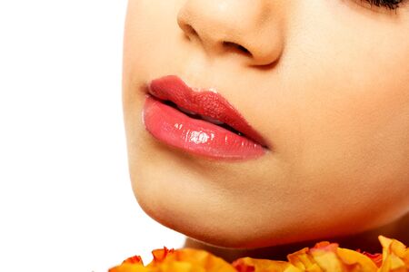 Beautiful female shiny pink lips with roses.の写真素材