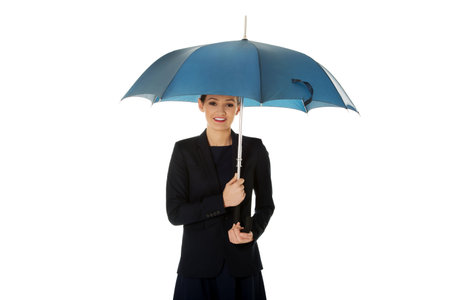 Beautiful business woman is holding blue umbrella.の写真素材