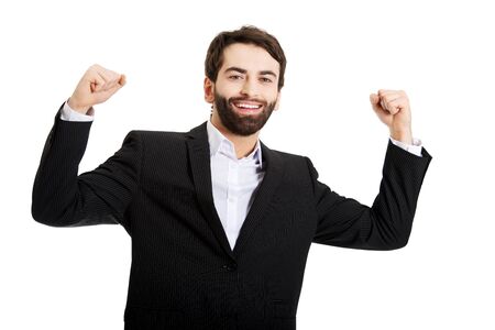 Successful businessman making fists in a winner gesture.の写真素材