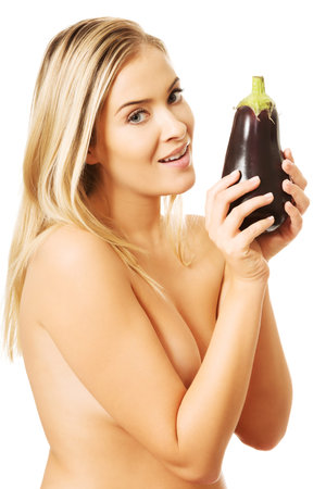 Shirtless smiling woman holding an aubergine.の写真素材