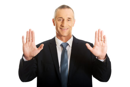 Mature businessman pressing abstract screen.