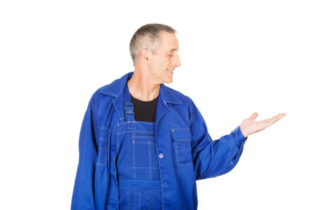 Repairman showing copyspace on palm.の写真素材