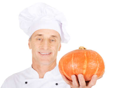 Male chef in uniform holding a pumpkinの写真素材