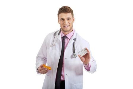 Male doctor or pharmacist holding pills.の写真素材