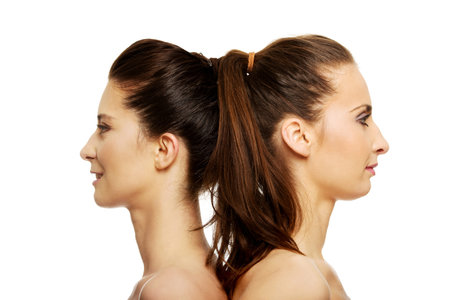 Two attractive topless sisters with make up.の写真素材