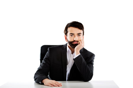 Smiling businessman sitting at the desk.の写真素材
