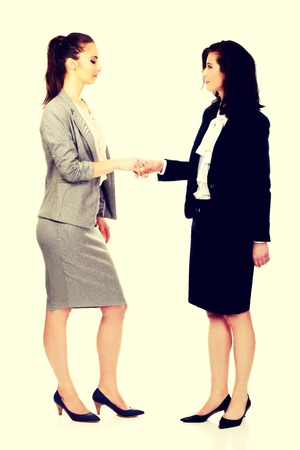 Beautiful two businesswomen giving handshake.の写真素材