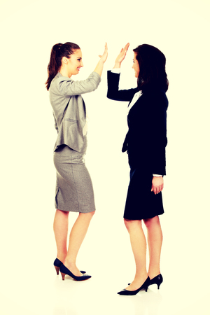 Two successful businesswoman giving a high five.の写真素材