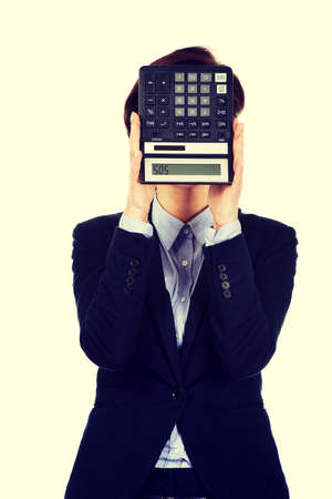 Hopeless businesswoman with SOS writing on calculator.の写真素材