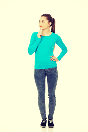 Thoughtful teenage woman looking up.の写真素材