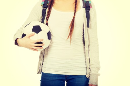 Teenager with schoolbag and foot ball.の写真素材