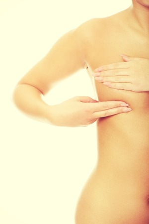 Woman examining breast mastopathy or cancer.の写真素材