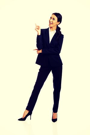 Happy businesswoman pointing at copyspace.の写真素材