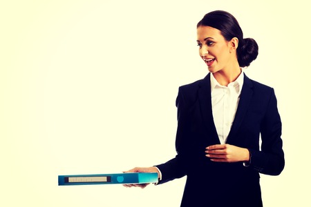 Businesswoman giving a binder to someone.の写真素材