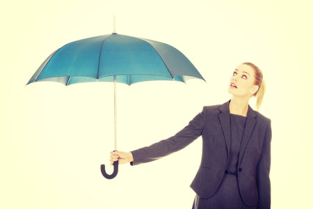 Attractive businesswoman holding an umbrella.の写真素材