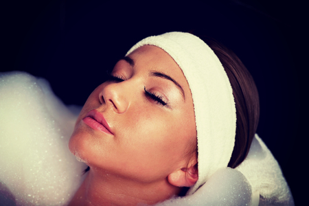 Beautiful bathing woman relaxing in bathtub.の写真素材