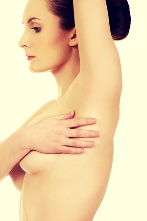 Beautiful topless woman covers her breast.の写真素材