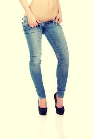 Slim female legs in jeans and high heel shoes.の写真素材