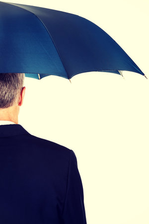 Back view businessman with umbrella.の写真素材