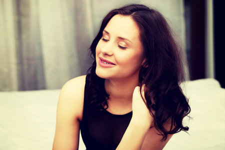 Beautiful woman wearing evening dress in bedroom.の写真素材