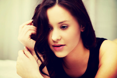 Beautiful woman wearing evening dress in bedroom.の写真素材