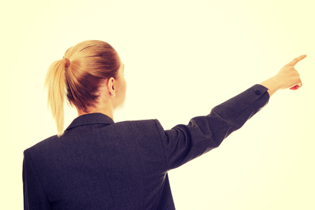 Young beautiful businesswoman pointing up.の写真素材