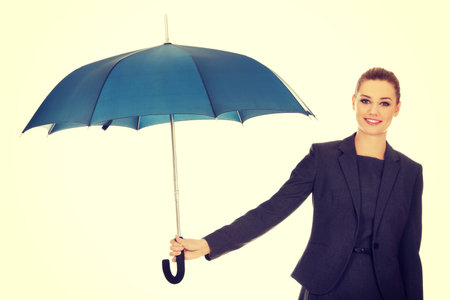 Attractive businesswoman holding an umbrella.の写真素材