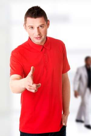 Serious young man pointing you.の写真素材