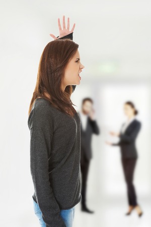 A very frustrated and angry woman screaming.の写真素材