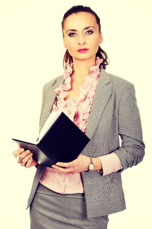 Beautiful businesswoman holding a notebook.の写真素材