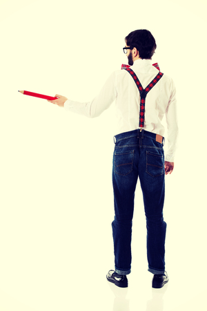 Funny man wearing suspenders pointing with big pencil.の写真素材