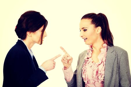 Two angry businesswomans pointing on each other.の写真素材