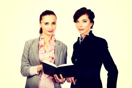 Two businesswomans with their notebook.の写真素材