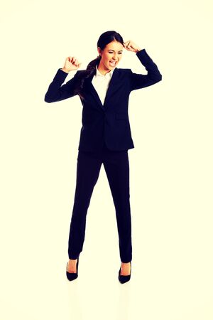 Agressive businesswoman screaming and pulling head.の写真素材